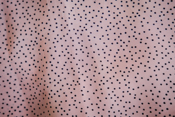 Polka dot silk fabric in nude pink color. Abstract background