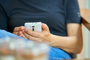 European female tourist checks her smartphone in the coffee shop