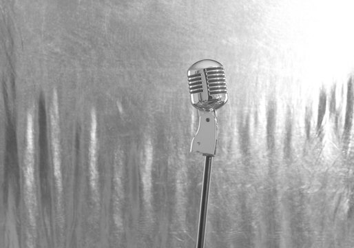 Retro microphone on bright background