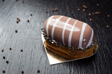 Eclairs with nuts. Brewed dough cake.