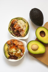 Two servings of healthy salmon rice for a nutrient-rich lifestyle with slices of avocado