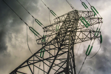 High pressure wire tower at the grey sky, support of power lines