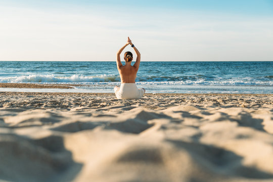 Woman meditating on beach