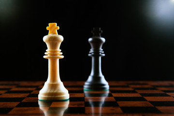 chess duel of two kings on a black background