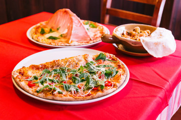 Neapolitan Pizza made with tomatoes, basil and mozzarella cheese.