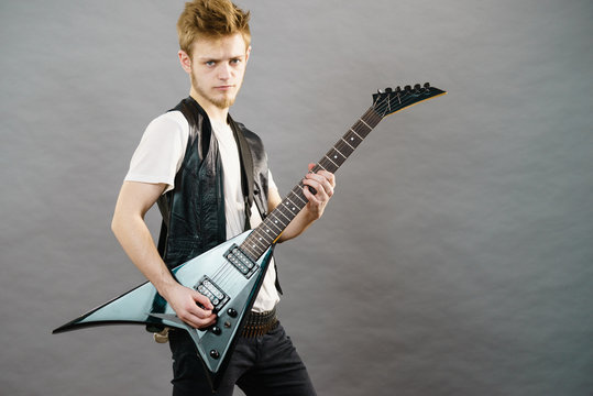 Young man playing electric guitar