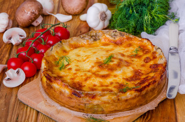 Baked pancakes (crepes) with mushrooms and bechamel sauce