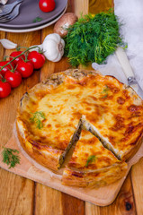Baked pancakes (crepes) with mushrooms and bechamel sauce