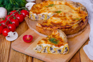 Baked pancakes (crepes) with mushrooms and bechamel sauce