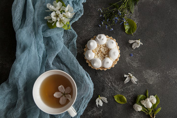 Obraz na płótnie Canvas meringue pie on a wooden table, dessert, cup of tea, tea