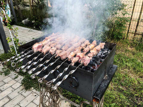 Mcvadi - shashlik preparing on a barbecue grill over charcoal. Roasted stacked meat Shish kebab popular in Goergia. Traditional cuisine in Georgia