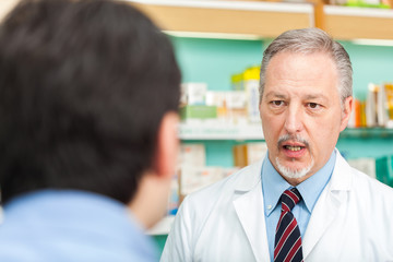 Pharmacist talking to a customer