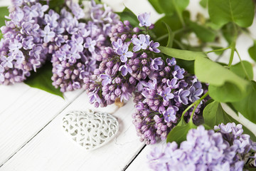 lilac branches on a white table, floristics, lilacs