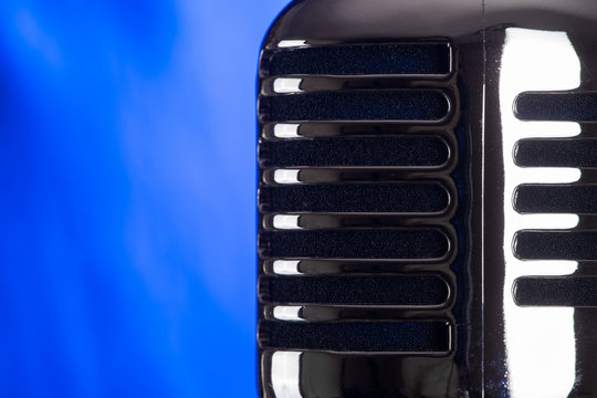 Retro microphone on bright background