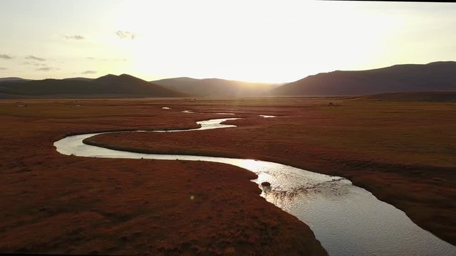 Aerial view from a drone of a river in a Mongolian steppe on an autumn day. Lake Khuvsgol, Mongolia.