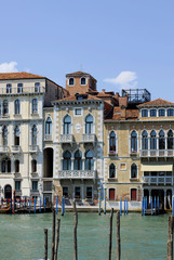 Fototapeta na wymiar Beautiful architecture Venice, Italy. Details of the windows and doors of the colorful houses. Street. Grand canal famous landmark panoramic view Venice Italy with blue sky white cloud.