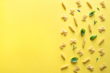 various pasta on yellow background
