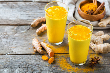 Traditional indian drink turmeric curcuma golden milk with ingredients - obrazy, fototapety, plakaty