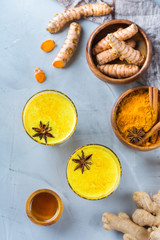 Traditional indian drink turmeric curcuma golden milk with ingredients
