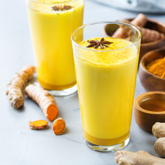 Traditional indian drink turmeric curcuma golden milk with ingredients