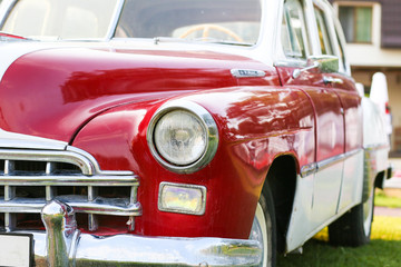 a headlight of a red vintage car. Old retro car