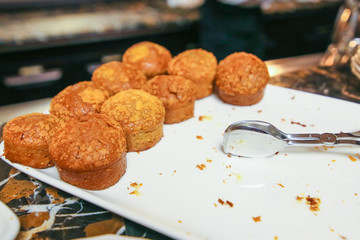 cupcakes on a white tray with a fork for self-service. Dessert for coffee