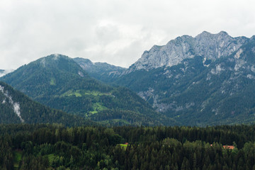 View on rocky Dachstein mountain peaks hills and forests from the balcony of the apartment