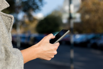 Close up of woman texting on mobile phone.