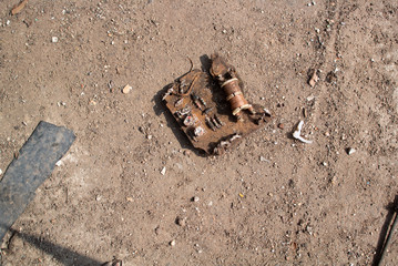 Rusted Electronics on sandy pavement