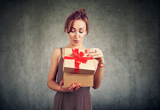 Excited Woman Opening Gift Box