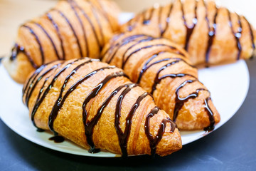 Croissants with chocolate on plate. 