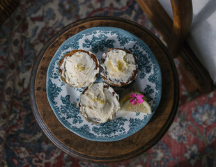 Vanilla cupcakes on blue plate seen from above