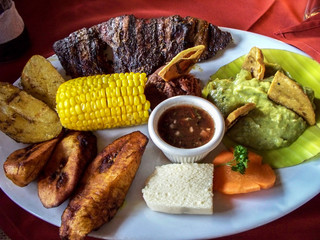 Latino food arrangement, Guatemala. corn, potatoes, meat, plantains, avocado, carrot, bread.