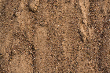 Fototapeta na wymiar Sand from red granite. Remains of small stones