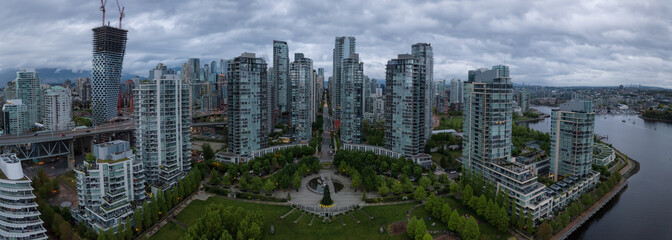 Aerial view of high rise buildings in Downtown City during a cloudy sunrise. Taken in Vancouver, BC, Canada.