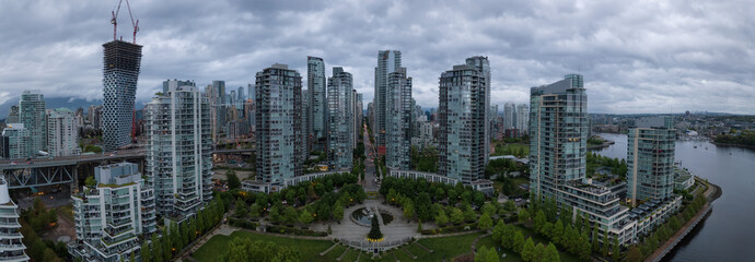 Fototapeta premium Aerial view of high rise buildings in Downtown City during a cloudy sunrise. Taken in Vancouver, BC, Canada.