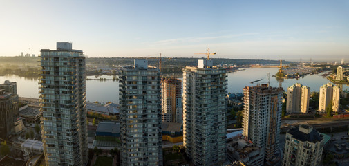 Obraz premium Aerial view of Residential Buildings in the city during a vibrant sunrise. Taken in New Westminster, Greater Vancouver, British Columbia, Canada.