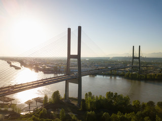 Aerial view of Alex Fraser Bridge during a vibrant sunny day. Taken in North Delta, Greater Vancouver, BC, Canada.