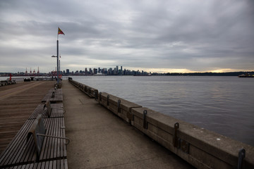 Naklejka premium North Vancouver, British Columbia, Canada - June 5, 2018: Downtown City viewed from Lonsdale during a cloudy sunset.