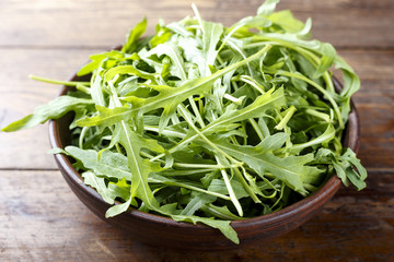 chopped arugula on a wooden background