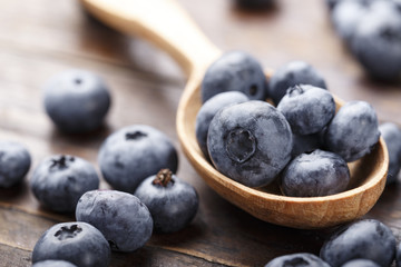 fresh blueberries in a wooden spoon