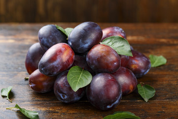 ripe plums on a wooden table