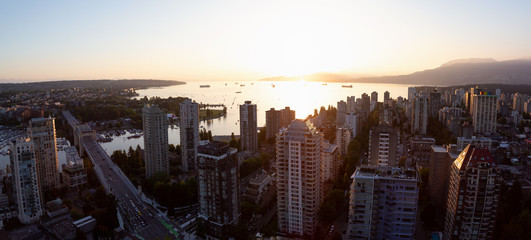 Beautiful aerial panoramic cityscape view during a vibrant sunny sunset. Taken in Downtown Vancouver, British Columbia, Canada.