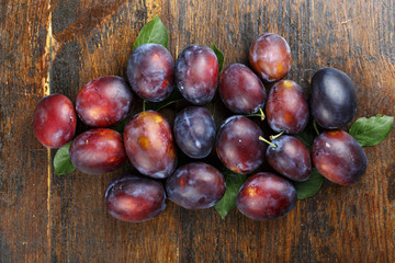 ripe plums on a wooden table
