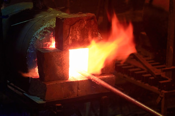 Blacksmith furnace, forge from which the tongues of flame.with metal bar. Homemade furnace with gas...