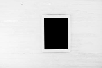 Big Black Empty Screen Smart Tablet Device With White Frame On White Wooden Background