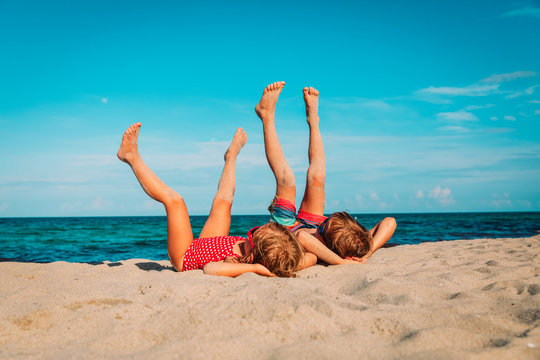 little boy and girl relax on tropical beach