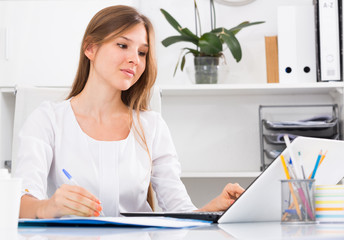 Young businesswoman at working place