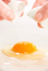 Organic Egg is Being Broken on Smooth Countertop