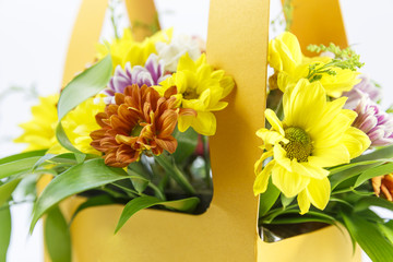 Bouquet of flowers in a yellow basket